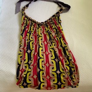 T-bags halter top with geometric pattern, chain neckline and velour ties.